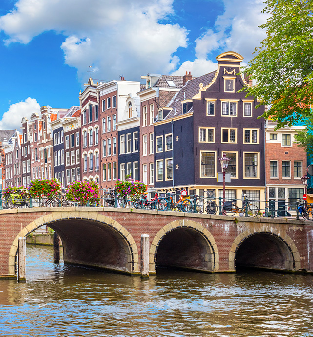 A bridge in Amsterdam over a canal with homes in the background