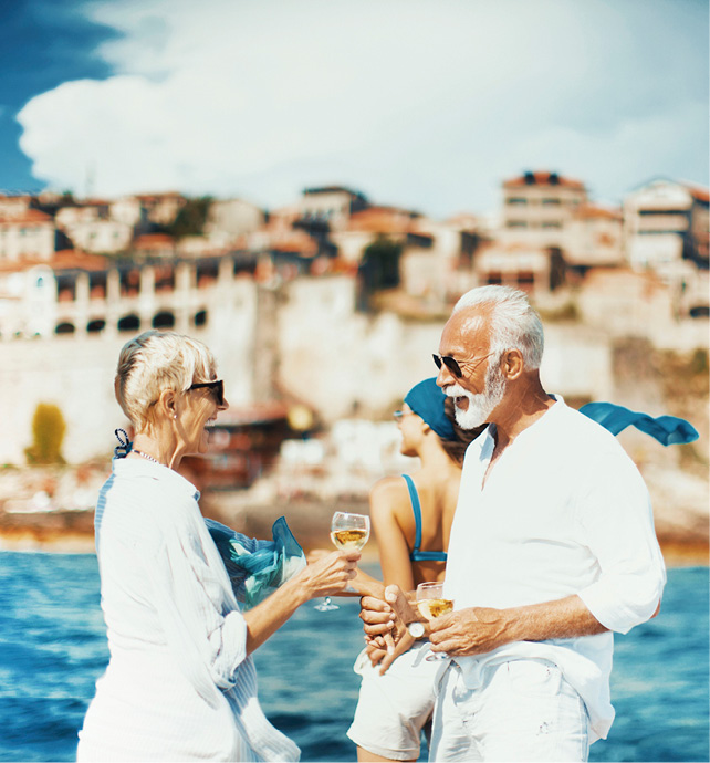 Couple drinking wine next to the coast