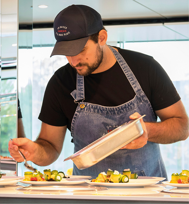 Chef preparing a delicious French inspired meal on board a luxury river ship