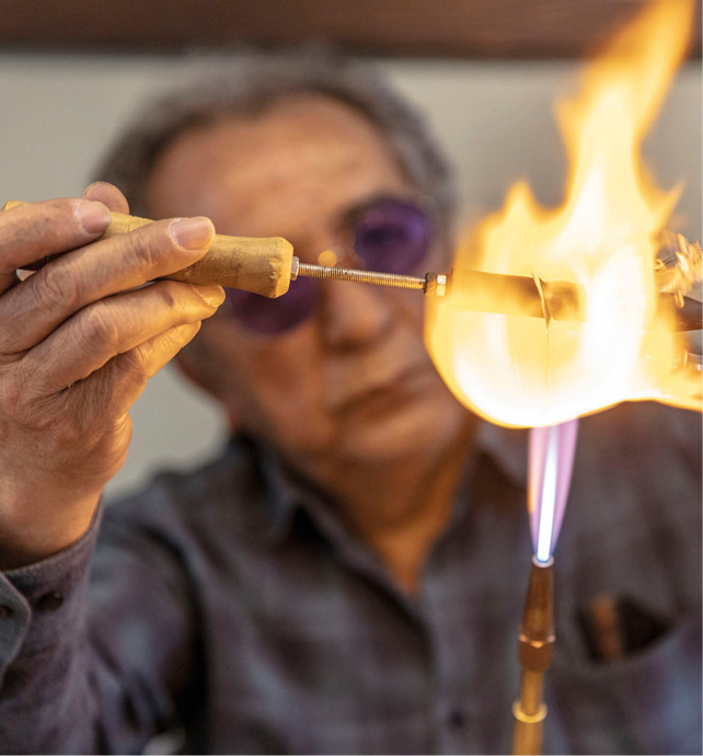 A glassblower works at the Glass Museum in Wertheim