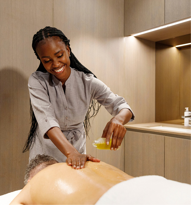 A guest receiving an ESPA oil massage on board a luxury yacht cruise